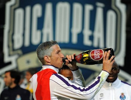 FC Porto's Marc Janko from Austria drinks beer as he celebrates winning