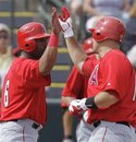 Los Angeles Angels ' Chris Iannetta , right, is congratulated by Alberto Callaspo after Iannetta hit a two-run home run during the third inning of a spring training baseball game against the Oakland Athletics on Monday, March 5, 2012, in Phoenix.