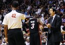 Miami Heat head coach Erik Spoelstra, right, argues with referee Eric Lewis (42) after a foul was called on Miami Heat's Dwyane Wade (3) during the second half of an NBA basketball game against the Orlando Magic , Sunday, March 18, 2012, in Miami. The Heat won 91-81.