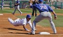 Chicago Cubs ' Starlin Castro is safe at third for a triple as Texas Rangers third baseman Mike Olt waits for the ball during the first inning of a spring training baseball game in Mesa, Ariz., Tuesday, March 20, 2012.