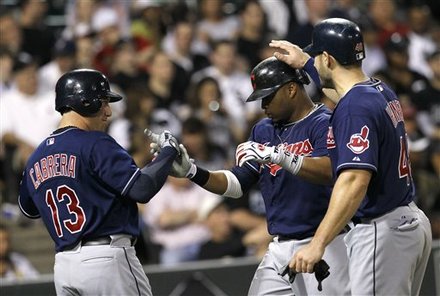 Cleveland Indians' Carlos Santana, Center, Celebrates His Three-run Home Run Off Chicago White Sox Starting Pitcher
