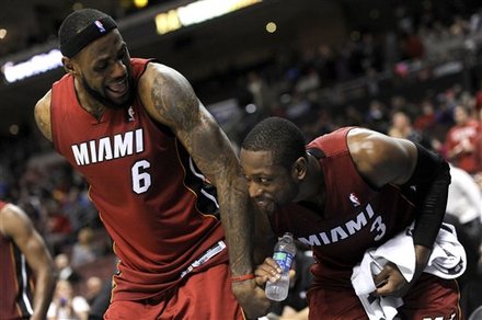 Miami Heats' LeBron James (6) And Dwyane Wade (3) Celebrate On The Bench At The End Of An NBA Basketball Game Against