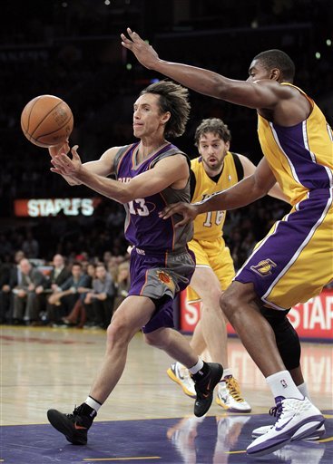 Phoenix Suns Guard Steve Nash, Center, Passes The Ball As He Is Defended By Los Angeles Lakers Center Andrew Bynum,