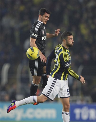 Serdar Kesimal Of Fenerbahce, Right, And Mustafa Pektemek Of Besiktas , Left, Fight For The Ball