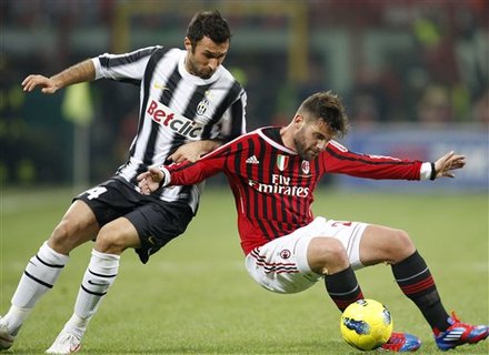 AC Milan Midfielder Antonio Nocerino, Right, Challenges For The Ball With Juventus Forward Mirko Vucinic, Of Montenegro,