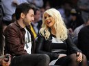 Christina Aguilera and Matt Rutler watch the Los Angeles Lakers play the Oklahoma City Thunder in their NBA basketball game, Thursday, March 29, 2012, in Los Angeles.