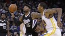 Sacramento Kings ' DeMarcus Cousins (15) drives the ball past Golden State Warriors ' Jeremy Tyler , right, during an NBA basketball game Saturday, March 24, 2012, in Oakland, Calif.
