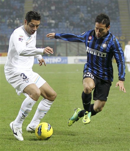 Inter Milan Defender Yuto Nagatomo, Left, Of Japan, Challenges For The Ball With Lazio's Andre Goncalves Dias, Of