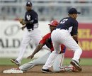 New York Yankees shortstop Derek Jeter (2) tags out Philadelphia Phillies ' Jimmy Rollins at second in their spring training baseball game at Steinbrenner Field in Tampa, Fla., Friday, March 30, 2012.