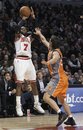 Chicago Bulls guard C.J. Watson (7) shoots over Phoenix Suns guard Steve Nash (13) during the second half of an NBA basketball game Tuesday, Jan. 17, 2012, in Chicago. The Bulls won 118-97 with Watson scoring 23 points.