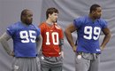 New York Giants ' Rocky Bernard (95), Eli Manning (10) and Chris Canty (99) watch practice, Saturday, Feb. 4, 2012, in Indianapolis. The Giants will face the New England Patriots in the NFL football Super Bowl XLVI on Feb. 5.