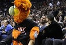 The Miami Heat mascot Burnie, left, sits on the lap of WBO heavyweight champion Wladimir Klitschko, second from right, of Ukraine, during an NBA basketball game between the Miami Heat and the Los Angeles Lakers , Thursday, Jan. 19, 2012, in Miami.