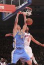 Denver Nuggets ' Timofey Mozgov (25), of Russia, dunks the ball as New York Knicks ' Jared Jeffries (9) defends during the second half of an NBA basketball game Saturday, Jan. 21, 2012, in New York. The Nuggets won the game 119-114.