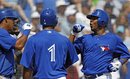 Toronto Blue Jays ' Yunel Esacobar, left, and Luis Valbuena , (1) congratulate teammate Edwin Encarnacion on his three-run home run off New York Yankees reliever Manuel Banuelos during the third inning of their spring training baseball game in Dunedin, Fla., Wednesday, March 14, 2012.