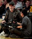 Director Steven Spielberg, left, talks to a cameraman during the second half on an NBA basketball game between the Los Angeles Lakers and the Portland Trail Blazers , Monday, Feb. 20, 2012, in Los Angeles.