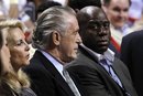 Miami Heat President Pat Riley, left, sits with Magic Johnson, right, during an NBA basketball game between the Heat and San Antonio Spurs , Tuesday, Jan. 17, 2012, in Miami.