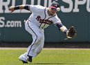 Atlanta Braves left fielder Eric Hinske reaches for a hit by New York Mets ' Justin Turner that landed for a double in the fourth inning of a spring training baseball game in Kissimmee, Fla., Monday, April 2, 2012.