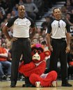 Chicago Bulls mascot Benny the Bull, center, hugs official Haywoode Workman, left, as he stands on the court with official Eric Lews during the first quarter of an NBA basketball game between the Portland Trail Blazers and the Chicago Bulls, Friday, March 16, 2012, in Chicago. The Trail Blazers won 100-89.