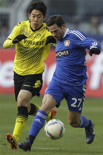 Dortmund's Shinji Kagawa Of Japan, Left, And Leverkusen's Gonzalo Castro Challenge For The Ball