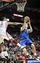 Dallas Mavericks forward Dirk Nowitzki (41), of Germany, shoots while defended by Houston Rockets guard Courtney Lee (5) during overtime of an NBA basketball game, Saturday, March 24, 2012, in Houston. The Mavericks won 101-99 in overtime. Nowitzki scored 31 points.