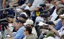 Baseball scouts use radar guns as New York Yankees ' Manny Banuelos pitches in the fifth inning of a spring training baseball game against the Philadelphia Phillies , Saturday, March 3, 2012, in Clearwater, Fla.