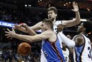 Memphis Grizzlies ' Marc Gasol , back, and O.J. Mayo , right, try to get a rebound against Oklahoma City Thunder center Cole Aldrich (45) in the first half of an NBA basketball game Wednesday, Dec. 28, 2011, in Memphis, Tenn. The Thunder won 98-95.