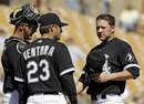 Chicago White Sox manager Robin Ventura (23) removes starting pitcher Jake Peavy , right, in the third inning of a spring training baseball game against the Oakland Athletics on Monday, March 12, 2012, in Glendale, Ariz.