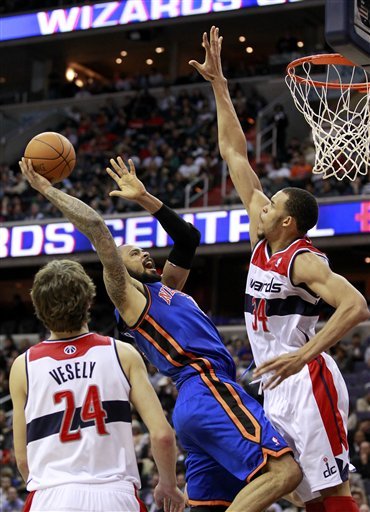 New York Knicks Center Tyson Chandler, Center, Goes To The Basket Against Washington Wizards Center JaVale McGee, Right,