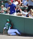 Boston Red Sox right fielder Alex Hassan slams into the wall while unsuccessfully trying to make the play on a foul off the bat of Baltimore Orioles ' Manny Machado during the sixth inning of a spring training baseball game in Fort Myers, Fla., Saturday, March 17, 2012.