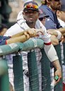 Boston Red Sox outfielder Carl Crawford watches from the dugout rail during the second inning of a spring training baseball game against the Tampa Bay Rays in Fort Myers, Fla., Tuesday, March 27, 2012. Crawford, who had surgery on his left wrist during the off-season, is not expected to be in the line up when the regular season begins.