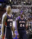 Atlanta Hawks ' Marvin Williams (24) and Jeff Teague (0) walk off the court after losing an NBA basketball game against the Philadelphia 76ers , Saturday, March 31, 2012, in Philadelphia. Philadelphia won 95-90.