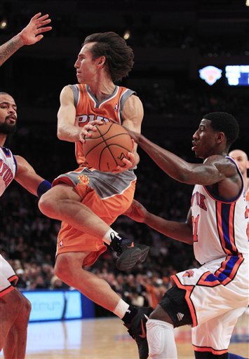 Phoenix Suns' Steve Nash, Center, Looks To Pass Away From New York Knicks' Iman Shumpert, Right, And Tyson Chandler,