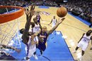 Los Angeles Lakers guard Derek Fisher (2) shoots in front of Oklahoma City Thunder center Kendrick Perkins , left, and forward Serge Ibaka (9), of Republic of Congo, in the second quarter of an NBA basketball game in Oklahoma City, Thursday, Feb. 23, 2012. Oklahoma City won 100-85.