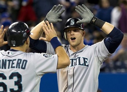 Seattle Mariners' Michael Saunders, Right, Celebrates