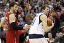 Dallas Mavericks power forward Dirk Nowitzki (41), of Germany, is fouled by Los Angeles Clippers point guard Chris Paul , center, as Blake Griffin (32) defends during the fourth quarter of an NBA basketball game in Dallas, Monday, Feb. 13, 2012. The Mavericks won 96-92.