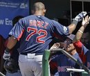 Boston Red Sox manager Bobby Valentine, lower right, congratulates Mauro Gomez (72) after Gomez hit a ninth-inning solo home run off Philadelphia Phillies reliever Tyson Brummett during the Red Sox 6-0 shutout of Philadelphia in their spring training baseball game in Clearwater, Fla., Monday, March 26, 2012.