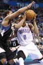 Oklahoma City Thunder guard Russell Westbrook , right, drives to the basket in front of Minnesota Timberwolves ' Derrick Williams , left, during the first quarter of a NBA basketball game in Oklahoma City, Friday, March 23, 2012. Oklahoma City won 149-140 in double overtime.