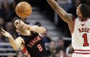 Toronto Raptors guard Jose Calderon (8) rebounds the ball against Chicago Bulls guard Derrick Rose (1) during the third quarter of an NBA basketball game in Chicago on Saturday, Jan. 14, 2012. The Bulls won 77-64.