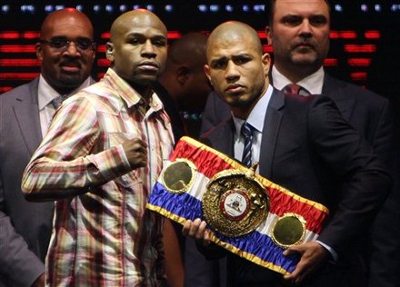 Miguel Cotto, The Reigning WBA Super Welterweight Champion, Right, And Boxer Floyd Mayweather Jr., Of The U.S., Pose