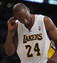 Los Angeles Lakers guard Kobe Bryant (24) holds his ear after getting hit by Golden State Warriors forward Jeremy Tyler during the second half of an NBA basketball game in Los Angeles, Sunday, April 1, 2012. The Lakers won 120-112.