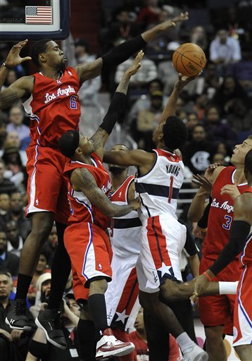 Los Angeles Clippers' DeAndre Jordan (6) And Teammate Mo Williams Defend Against Washington Wizard Nick Young's Shot