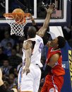 Los Angeles Clippers guard Nick Young , right, dunks in front of Oklahoma City Thunder forward Serge Ibaka during the third quarter of an NBA basketball game in Oklahoma City, Wednesday, March 21, 2012. Oklahoma City won 114-91.