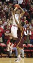 Indiana's Christian Watford puts up a shot against Minnesota's Andre Hollins  in the closing second of an NCAA college basketball game Thursday, Jan. 12, 2012, in Bloomington, Ind. Watford missed the shot, and Minnesota defeated Indiana 77-74.