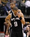 San Antonio Spurs ' Tony Parker (9) pauses after Tim Duncan , rear, was charged with a foul late in the second half of an NBA basketball game against the Dallas Mavericks on Saturday, March 17, 2012, in Dallas. The Mavericks won 106-99.