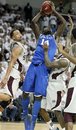 Kentucky forward Michael Kidd-Gilchrist (14) bullies his way to a shot on basket against Mississippi State defenders Jalen Steele, left, and Dee Bost, right, in the second half of their NCAA college basketball game in Starkville, Miss., Tuesday, Feb. 21, 2012. No. 1 Kentucky won 73-64.