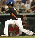 Miami Marlins ' Jose Reyes gets a base hit in the third inning of a spring training baseball game against the Washington Nationals in Jupiter, Fla., Friday, March 9, 2012. Bryan Peterson scored on the play and Miami won 3-0.