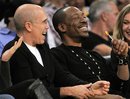 Actor Eddie Murphy, right, watches the Los Angeles Lakers play the Sacramento Kings in their NBA basketball game along with producer Jeffrey Katzenberg, Friday, March 2, 2012, in Los Angeles.