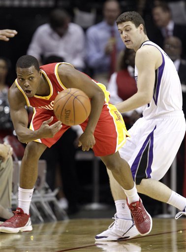 Houston Rockets' Kyle Lowry, Left, Keeps The Ball From Going Out Of Bounds As Sacramento Kings' Jimmer Fredette, Right,