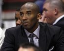 Los Angeles Lakers ' Kobe Bryant watches from the bench during the first half of an NBA basketball game against the Phoenix Suns , Saturday, April 7, 2012, in Phoenix.