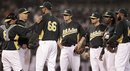 Oakland Athletics pitching coach Curt Young, second from left, speaks with Tyson Ross (66) during the fourth inning of an exhibition baseball game against the San Francisco Giants on Tuesday, April 3, 2012, in Oakland, Calif.